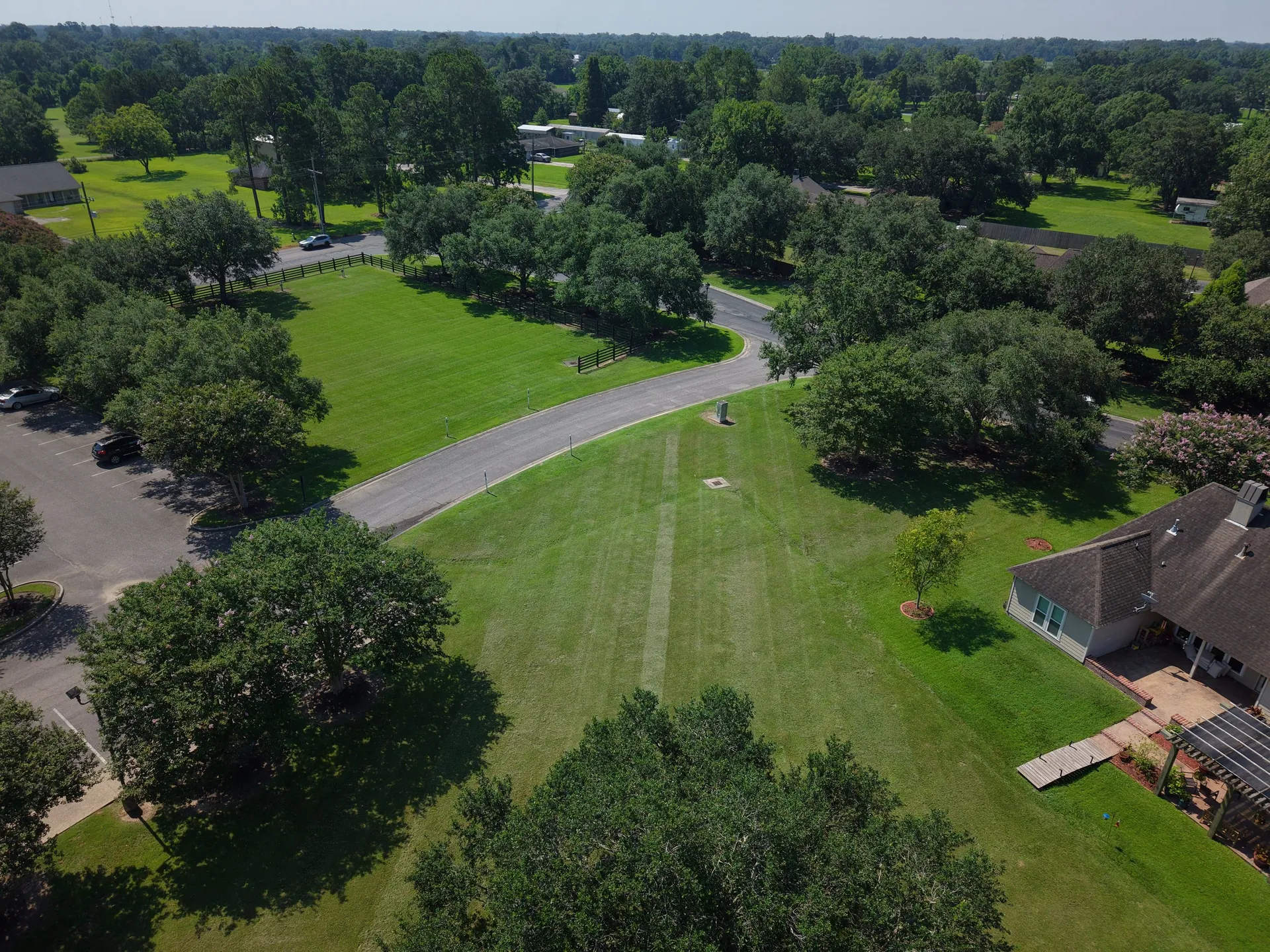 Aerial view of a maintained HOA subdivision entrance and common areas in Prairieville, Louisiana